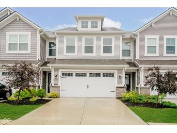 Charming townhome featuring an attached two car garage, manicured landscaping and inviting curb appeal at 9634 Beckett St, Avon, IN 46123