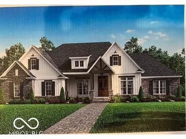 Charming single-story home with a combination of stone and siding, complemented by a neatly landscaped yard and brick walkway at 14338 Laura Vista Dr, Carmel, IN 46033