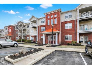 Inviting brick condominium with manicured landscaping, covered entry, and ample parking at 17223 Gunther Blvd # 310, Westfield, IN 46074