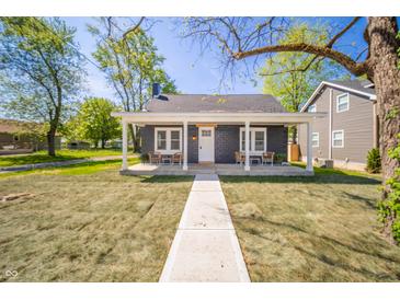 Charming home with a covered front porch and freshly manicured lawn, perfect for curb appeal at 227 W 7Th St, Lapel, IN 46051
