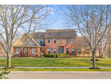 Attractive exterior view of two story brick home with a well maintained lawn and mature trees at 6045 Channel Dr, Columbus, IN 47201