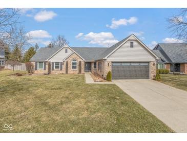 Charming single-Gathering home featuring a brick facade, well-kept lawn, and a two-car attached garage at 9046 Pinecreek Ct, Indianapolis, IN 46256