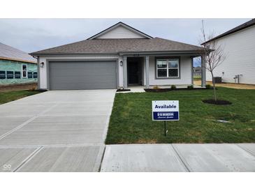 Charming single-story home with a gray garage door, fresh landscaping, and an inviting, covered entryway at 11305 N Quillow Way, Monrovia, IN 46157