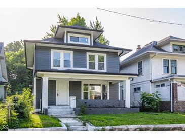 Charming home featuring new siding, complemented by a welcoming front porch and landscaped yard at 3543 N Kenwood Ave, Indianapolis, IN 46208