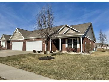 Charming brick home with a manicured lawn, two-car garage, and covered porch at 4310 Yarrow Ct, Indianapolis, IN 46237