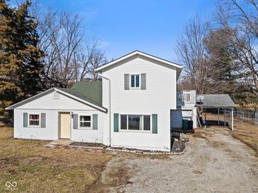 Charming two-story home featuring white siding, green shutters and a covered parking area at 6724 E Spring Lake Rd, Mooresville, IN 46158