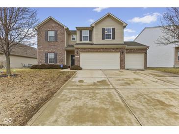 Inviting two-story home with brick and siding, a well-manicured lawn, and a convenient two-car garage at 8547 S Tibbs Ave, Indianapolis, IN 46217