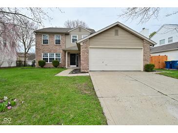 Charming two-story home with a brick and vinyl facade, complemented by a well-maintained lawn and an attached two-car garage at 9685 Glowing Flame Dr, Fishers, IN 46037