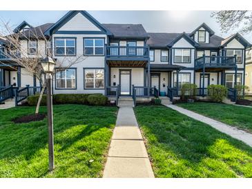 Charming townhome exterior showcasing blue trim, inviting walkway, and well-maintained landscaping at 2357 Central Ave, Indianapolis, IN 46205