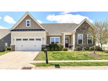 Charming single-Gathering home features a well-manicured lawn and an attached two-car garage at 2564 Tangleridge Ln, Brownsburg, IN 46112