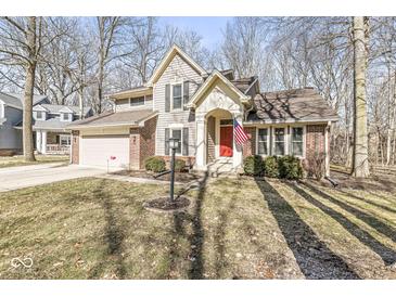 Charming two-story home featuring a red front door and brick and siding exterior at 4947 Cherryhill Ct, Indianapolis, IN 46254