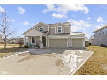 Inviting two-story home with attached two car garage, covered porch and well-kept landscaping at 6705 Park Grove Blvd, Whitestown, IN 46075
