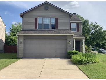 Charming two-story home featuring a two-car garage and well-maintained landscaping, perfect for Gathering living at 10419 Dark Star Dr, Indianapolis, IN 46234