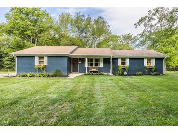 Charming single story home with blue brick, complemented by a lush green lawn and beautiful landscaping at 11710 Prairie Pl, Carmel, IN 46033