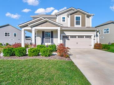 Charming two-story home featuring a well-manicured lawn and a two-car garage, complete with welcoming curb appeal at 12650 Sunrise Dr, Noblesville, IN 46060