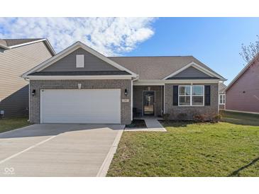 Charming single-story home featuring brick accents, gray siding, a two-car garage, and a well-manicured lawn at 293 Carrick Glen Blvd, Pendleton, IN 46064
