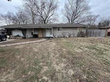 Ranch-style home with gray siding, a covered porch, and a walkway leading to the front door at 7643 S Delaware St, Indianapolis, IN 46227