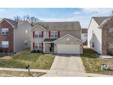 Charming two-story home with a brick facade, red shutters, and a well-manicured lawn at 11005 Long Lake Ln, Fishers, IN 46037