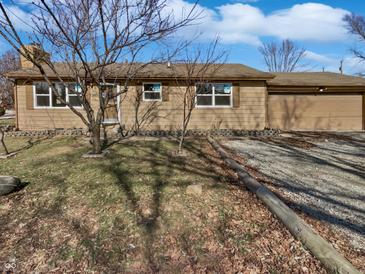 Ranch home with a gravel drive and an attached garage at 102 Plummer Ave, Bargersville, IN 46106