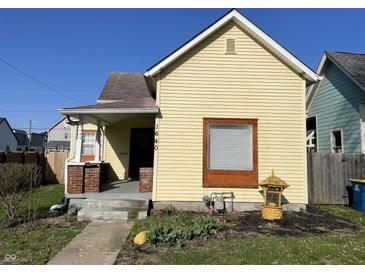 Charming yellow single Gathering home with a cozy porch and well-kept front yard, great curb appeal at 1640 Bellefontaine St, Indianapolis, IN 46202