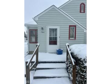 Inviting front entrance of this home with red trim around the windows and door at 504 E Walnut St, Summitville, IN 46070