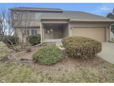 Charming two-story home with neutral siding, landscaping, and attached garage at 6462 Zionsville Rd, Indianapolis, IN 46268