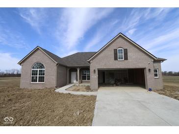 New construction single-Gathering home with gray brick, large garage and driveway under a blue sky at 10502 Oak Bend Blvd, Indianapolis, IN 46239