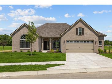 Charming single-story home with a two-car garage and well-manicured lawn at 10502 Oak Bend Blvd, Indianapolis, IN 46239