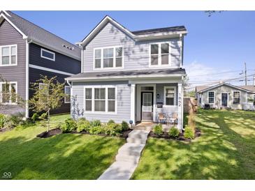 Charming two-story home features a well-maintained front yard, inviting entrance, and classic architectural details at 1842 Milburn St, Indianapolis, IN 46202