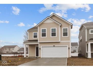 Charming two-story home featuring a two-car garage and neutral siding under a blue sky at 5119 Rolling Meadow Blvd, Indianapolis, IN 46237