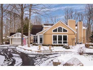 Charming home exterior featuring a circular driveway, lovely windows and well manicured landscaping at 6842 Cardinal Dr, McCordsville, IN 46055