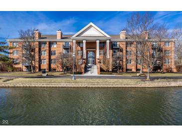 An inviting brick condo with balconies, columns, and waterfront views at 8690 Jaffa Ct W Dr # 18, Indianapolis, IN 46260