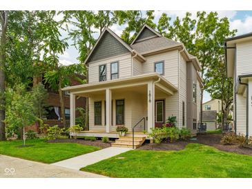 Charming two-story home with a welcoming front porch and well-maintained lawn at 1818 Central Ave, Indianapolis, IN 46202