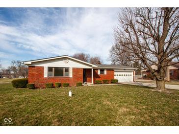 Charming brick ranch home featuring an attached garage and well-maintained front yard at 2566 S Ritter Ave, Indianapolis, IN 46203