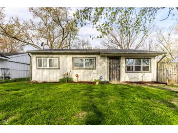 Attractive single-Gathering home showcasing a tidy front lawn and secure entrance at 3944 Strathmore Dr, Indianapolis, IN 46235