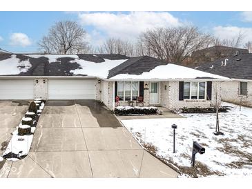 Charming single-story home with a white brick facade and a spacious driveway at 4501 N Wheeling Ave # 10A-101, Muncie, IN 47304