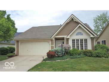 Charming home with a well-manicured lawn, attached garage, and inviting curb appeal at 6564 Aintree Pl, Indianapolis, IN 46250
