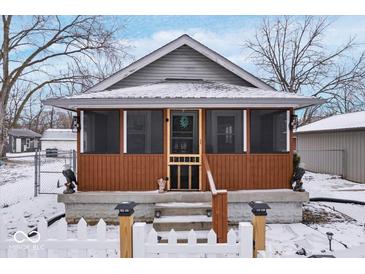 Charming bungalow featuring a cozy screened front porch and meticulous landscaping at 2337 Collier St, Indianapolis, IN 46241