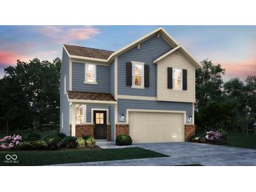 Charming two-story home featuring a large garage and a mix of blue siding and brick accents at 3302 Wetherby Pl, Danville, IN 46122