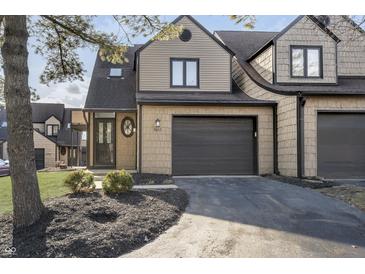 Charming townhouse featuring a private entrance, one-car garage, and meticulously landscaped front yard at 9652 Highgate N Cir, Indianapolis, IN 46250