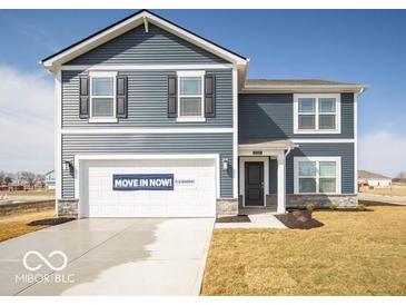 Charming two-story home features a blue facade, attached garage and inviting front entrance at 11322 N Quillow Way, Monrovia, IN 46157