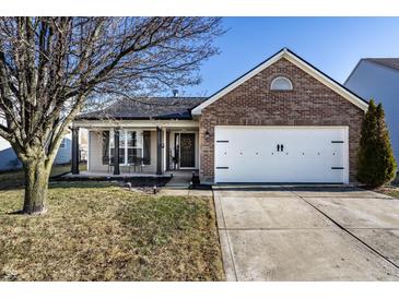 Charming single-Gathering home showcasing a brick facade and two-car garage at 3037 Knobstone Ln, Indianapolis, IN 46203