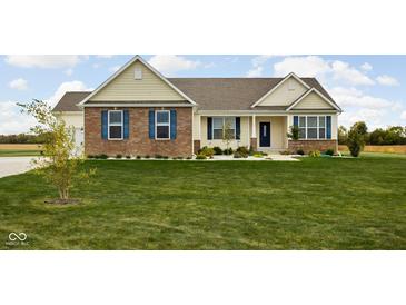 Inviting single Gathering home with brick accents, blue shutters, and a manicured lawn at 8225 W 825 N, Thorntown, IN 46071