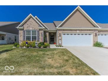 Charming single-story home with brick accents, landscaped yard, and attached two-car garage at 8724 Faulkner Dr, Indianapolis, IN 46239