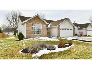 Charming single Gathering home featuring a combination of brick and vinyl siding, with attached garage and landscaped front yard at 10669 Springston Ct, Fishers, IN 46037