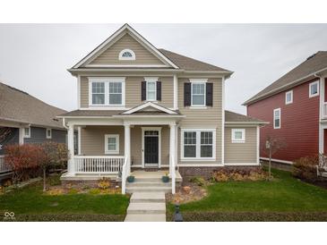 Charming two-story home with neutral siding, black shutters, covered porch, and well-manicured lawn at 12991 Pennington Rd, Fishers, IN 46037