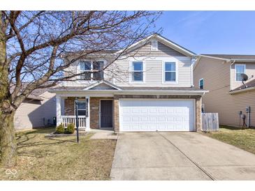 Inviting two-story home featuring a two-car garage, and a welcoming front porch at 15486 Dusty Trl, Noblesville, IN 46060