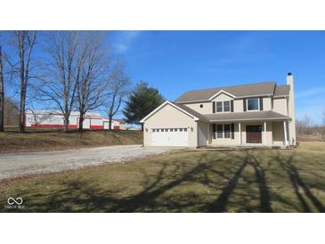 Charming two-story home with an attached two car garage, spacious yard, and a large barn at 1588 E Us Highway 136, Hillsboro, IN 47949