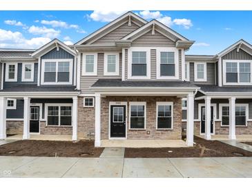 Inviting two-story townhome with stone accents, stylish siding, and covered porch at 19487 Grassy Branch Rd, Westfield, IN 46074