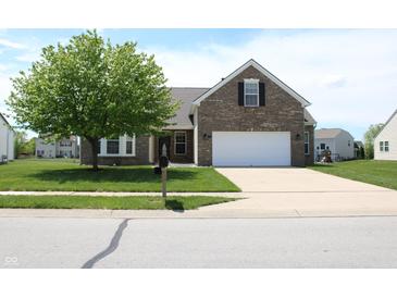 Charming brick home with a two-car garage and a well-manicured front yard at 2228 Silver Rose Dr, Avon, IN 46123